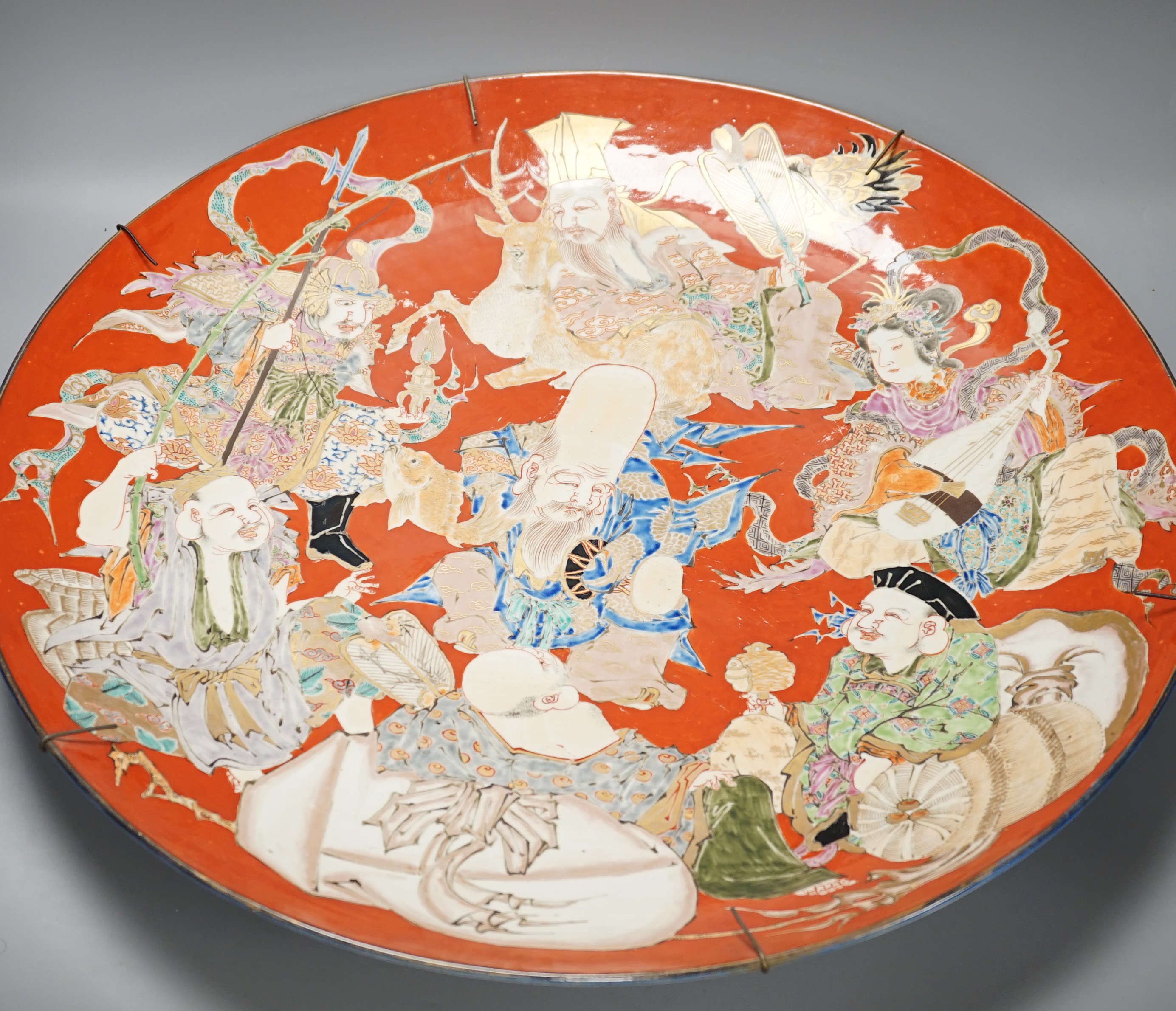 A massive Japanese Arita 'Seven Gods of Happiness' dish, Meiji period, 60.5cm.
